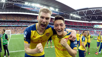LONDON, ENGLAND - MAY 30: (L-R) Arsenal's Per Mertesacker and Mesut Ozil celebrate after the FA Cup Final between Aston Villa and Arsenal at Wembley Stadium on May 30, 2015 in London, England. (Photo by Stuart MacFarlane/Arsenal FC via Getty Images)