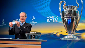 UEFA director of competitions Giorgio Marchetti shows the slip of Chelsea FC next to the Champions League trophy during the draw for the round of 16 of the UEFA Champions League football tournament at the UEFA headquarters in Nyon on December 11, 2017. / AFP PHOTO / Fabrice COFFRINI (Photo credit should read FABRICE COFFRINI/AFP/Getty Images)