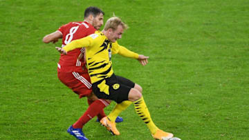 Dortmund's German forward Julian Brandt (R) vies with with Bayern Munich's Spanish midfielder Javier Martinez during the German Supercup football match FC Bayern Munich v BVB Borussia Dortmund in Munich, Southern Germany, on September 30, 2020. (Photo by ANDREAS GEBERT / POOL / AFP) / DFL REGULATIONS PROHIBIT ANY USE OF PHOTOGRAPHS AS IMAGE SEQUENCES AND/OR QUASI-VIDEO (Photo by ANDREAS GEBERT/POOL/AFP via Getty Images)