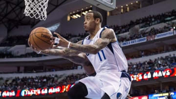 Jan 13, 2014; Dallas, TX, USA; Dallas Mavericks shooting guard Monta Ellis (11) drives to the basket past Orlando Magic power forward Glen Davis (11) during the first half at the American Airlines Center. Mandatory Credit: Jerome Miron-USA TODAY Sports
