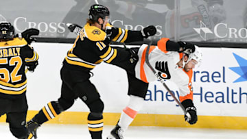 Jan 21, 2021; Boston, Massachusetts, USA; Boston Bruins center Trent Frederic (11) checks Philadelphia Flyers defenseman Mark Friedman (3) during the first period at the TD Garden. Mandatory Credit: Brian Fluharty-USA TODAY Sports