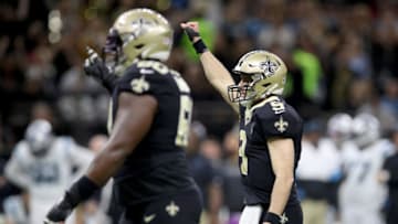 NEW ORLEANS, LOUISIANA - NOVEMBER 24: Drew Brees #9 of the New Orleans Saints celebrates a touchdown scored by Jared Cook #87 against the Carolina Panthers during the third quarter in the game at Mercedes Benz Superdome on November 24, 2019 in New Orleans, Louisiana. (Photo by Chris Graythen/Getty Images)
