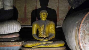 DAMBULLA, SRI LANKA- APRIL 10: A Buddha statue sits at the Rangiri Dambulla Cave Temple, or Rock Temple, on April 10, 2019 in Dambulla, Sri Lanka. The cave monastery is a UNESCO world heritage site and is said to be the best preserved cave temple complex in Sri Lanka. (Photo by Yuriko Nakao/Getty Images)