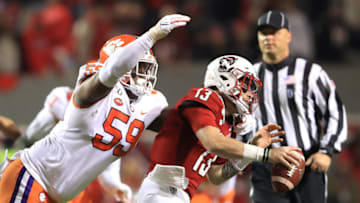 RALEIGH, NORTH CAROLINA - NOVEMBER 09: Jordan Williams #59 of the Clemson Tigers sacks Devin Leary #13 of the North Carolina State Wolfpack during their game at Carter-Finley Stadium on November 09, 2019 in Raleigh, North Carolina. (Photo by Streeter Lecka/Getty Images)