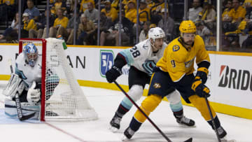 NASHVILLE, TN - OCTOBER 14: Filip Forsberg #9 of the Nashville Predators skates the puck behind the Seattle Kraken goal during the third period at Bridgestone Arena on October 14, 2021 in Nashville, Tennessee. Seattle defeats Nashville 4-3. (Photo by Brett Carlsen/Getty Images)