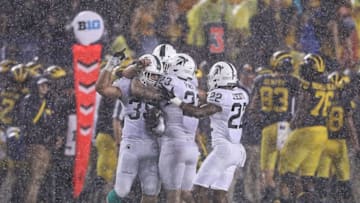 ANN ARBOR, MI - OCTOBER 07: Joe Bachie #35 of the Michigan State Spartans celebrates with his team after intercepting the ball during the third quarter of the game against the Michigan Wolverines at Michigan Stadium on October 7, 2017 in Ann Arbor, Michigan. Michigan State defeated Michigan 14-10. (Photo by Leon Halip/Getty Images)