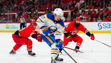 Nov 7, 2023; Raleigh, North Carolina, USA; Buffalo Sabres center Casey Mittelstadt (37) gets a scoring chance in the overtime against Carolina Hurricanes center Jordan Staal (11) and defenseman Brent Burns (8) at PNC Arena. Mandatory Credit: James Guillory-USA TODAY Sports