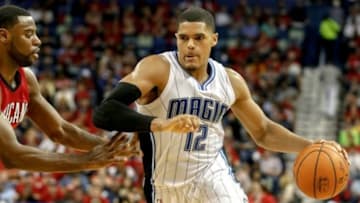 Oct 28, 2014; New Orleans, LA, USA; Orlando Magic forward Tobias Harris (12) drives past New Orleans Pelicans guard Tyreke Evans (1) during the third quarter of a game at the Smoothie King Center. The Pelicans defeated the Magic 101-84. Mandatory Credit: Derick E. Hingle-USA TODAY Sports
