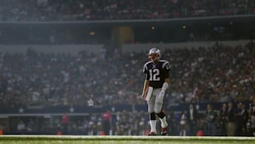 Oct 11, 2015; Arlington, TX, USA; New England Patriots quarterback Tom Brady (12) takes the field as sunbeams cut across the field during the game against the Dallas Cowboys at AT&T Stadium. Mandatory Credit: Matthew Emmons-USA TODAY Sports