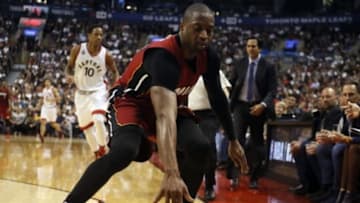 Jan 22, 2016; Toronto, Ontario, CAN; Miami Heat guard Dwyane Wade (3) reaches for a ball against the Toronto Raptors at the Air Canada Centre. Toronto defeated Miami 101-81. Mandatory Credit: John E. Sokolowski-USA TODAY Sports