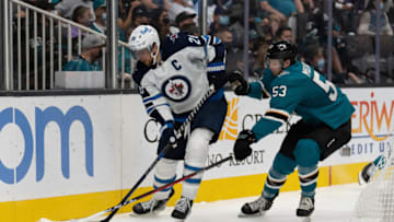 Oct 30, 2021; San Jose, California, USA; San Jose Sharks defenseman Nicolas Meloche (53) attempts to defend against Winnipeg Jets defenseman Nathan Beaulieu (28) during the third period at SAP Center at San Jose. Mandatory Credit: Stan Szeto-USA TODAY Sports
