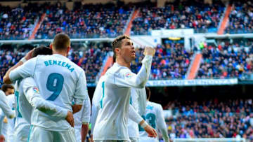 Real Madrid's Portuguese forward Cristiano Ronaldo (R) celebrates after scoring afduring the Spanish league football match between Real Madrid CF and Deportivo Alaves at the Santiago Bernabeu stadium in Madrid on February 24, 2018. / AFP PHOTO / PIERRE-PHILIPPE MARCOU (Photo credit should read PIERRE-PHILIPPE MARCOU/AFP/Getty Images)
