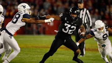 AMES, IA - OCTOBER 13: Running back David Montgomery #32 of the Iowa State Cyclones drives the ball between linebacker Rashon Lusane #28, and safety Jovanni Stewart #9 of the West Virginia Mountaineers in the first half of play at Jack Trice Stadium on October 13, 2018 in Ames, Iowa. (Photo by David Purdy/Getty Images)