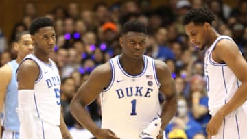 DURHAM, NORTH CAROLINA - FEBRUARY 20: Teammates RJ Barrett #5 and Marques Bolden #20 of the Duke Blue Devils watch as Zion Williamson #1 of the Duke Blue Devils reacts after falling as his shoe breaks against Luke Maye #32 of the North Carolina Tar Heels during their game at Cameron Indoor Stadium on February 20, 2019 in Durham, North Carolina. (Photo by Streeter Lecka/Getty Images)
