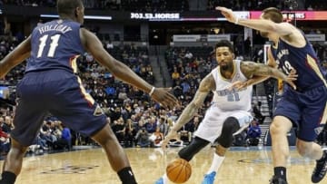 Dec 15, 2013; Denver, CO, USA; Denver Nuggets shooting guard Wilson Chandler (21) dribbles the ball around New Orleans Pelicans power forward Ryan Anderson (33) and point guard Jrue Holiday (11) in the first quarter at the Pepsi Center. Mandatory Credit: Isaiah J. Downing-USA TODAY Sports
