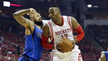 Apr 18, 2015; Houston, TX, USA; Houston Rockets center Dwight Howard (12) controls the ball during the first quarter as Dallas Mavericks center Tyson Chandler (6) defends in game one of the first round of the NBA Playoffs at Toyota Center. Mandatory Credit: Troy Taormina-USA TODAY Sports