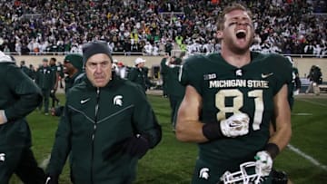 EAST LANSING, MI - NOVEMBER 04: Matt Sokol #81 of the Michigan State Spartans celebrates a 27-24 win over the Penn State Nittany Lions next to head coach Mark Dantonio at Spartan Stadium on November 4, 2017 in East Lansing, Michigan. (Photo by Gregory Shamus/Getty Images)