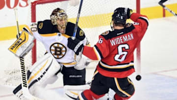 Dec 4, 2015; Calgary, Alberta, CAN; Calgary Flames defenseman Dennis Wideman (6) avoids a shot on Boston Bruins goalie Tuukka Rask (40) at Scotiabank Saddledome. Flames won 5-4 in overtime. Mandatory Credit: Candice Ward-USA TODAY Sports