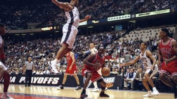 29 Apr 1998: Michael Jordan #23 of the Chicago Bulls in action against Jason Williams #55 of the New Jersey Nets during the NBA Playoffs round 3 game at the Continental Airlines Arena in East Rutherford, New Jersey. The Bulls defeated the Nets 116-101.