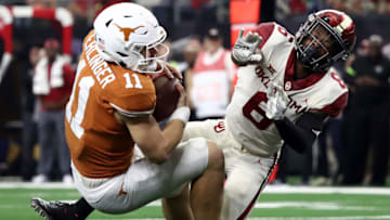 ARLINGTON, TEXAS - DECEMBER 01: Sam Ehlinger #11 of the Texas Longhorns is tackled by Tre Brown #6 of the Oklahoma Sooners for a safety in the fourth quarter at AT&T Stadium on December 01, 2018 in Arlington, Texas. (Photo by Ronald Martinez/Getty Images)