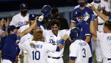 LOS ANGELES, CA - AUGUST 22: Cody Bellinger #35 of the Los Angeles Dodgers is congratulated at home plate after hitting a game-winning walk off home run off relief pitcher Daniel Bard #52 of the Colorado Rockies to defeat the Rockies 4-3 in the ninth inning at Dodger Stadium on August 22, 2020 in Los Angeles, California. (Photo by Kevork Djansezian/Getty Images)