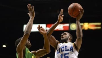 March 16, 2013; Las Vegas, NV, USA; UCLA Bruins guard/forward Shabazz Muhammad (15) shoots against Oregon Ducks guard Damyean Dotson (21) during the second half of the championship game of the Pac 12 tournament at the MGM Grand Garden Arena. Oregon defeated UCLA 78-69. Mandatory Credit: Kyle Terada-USA TODAY Sports