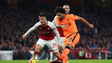 LONDON, ENGLAND - DECEMBER 22: Mohamed Salah of Liverpool shoots as Granit Xhaka of Arsenal looks on during the Premier League match between Arsenal and Liverpool at Emirates Stadium on December 22, 2017 in London, England. (Photo by Julian Finney/Getty Images)