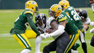 Nov 15, 2020; Green Bay, Wisconsin, USA; Green Bay Packers safety Darnell Savage (26) and linebacker Preston Smith (91) tackle Jacksonville Jaguars running back James Robinson (30) during the third quarter at Lambeau Field. Mandatory Credit: Tork Mason/USA TODAY NETWORK-Wisconsin via USA TODAY NETWORK
