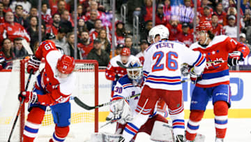 WASHINGTON, DC - FEBRUARY 24: Washington Capitals center Nicklas Backstrom (19) tries to control the loose puck after a first period save by New York Rangers goaltender Henrik Lundqvist (30) on February 24, 2019, at the Capital One Arena in Washington, D.C. (Photo by Mark Goldman/Icon Sportswire via Getty Images)