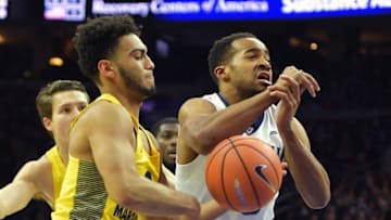 VILLANOVA, PA - JANUARY 06: Phil Booth #5 of the Villanova Wildcats gets the ball knocked away by Markus Howard #0 of the Marquette Golden Eagles at The Wells Fago Center on January 6, 2018 in Philadelphia, Pennsylvania. (Photo by Drew Hallowell/Getty Images)