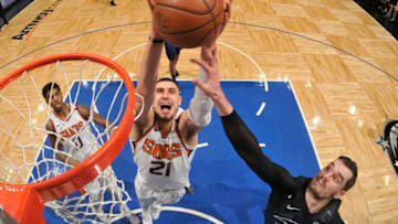 ORLANDO, FL - MARCH 24: Alex Len #21 of the Phoenix Suns grabs the rebound against the Orlando Magic on March 24, 2018 at Amway Center in Orlando, Florida. NOTE TO USER: User expressly acknowledges and agrees that, by downloading and/or using this photograph, user is consenting to the terms and conditions of the Getty Images License Agreement. Mandatory Copyright Notice: Copyright 2018 NBAE (Photo by Fernando Medina/NBAE via Getty Images)