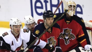 Feb 25, 2016; Sunrise, FL, USA; Florida Panthers defenseman Erik Gudbranson (44) defends goalie Roberto Luongo (1) as Arizona Coyotes center Martin Hanzal (11) and center Tobias Rieder (8) battle for position in the third period at BB&T Center. The Panthers won 3-2. Mandatory Credit: Robert Mayer-USA TODAY Sports