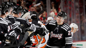 Michael McLeod #20 of the New Jersey Devils celebrates his goal with teammates on the bench during the third period against the Philadelphia Flyers at Prudential Center on December 08, 2021 in Newark, New Jersey. Tonight the New Jersey Devils are wearing their newly designed third jersey. This was the first goal of the season for McLeod. The New Jersey Devils shut out the Philadelphia Flyers 3-0. (Photo by Elsa/Getty Images)