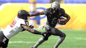 Sep 26, 2020; Pittsburgh, Pennsylvania, USA; Pittsburgh Panthers wide receiver Tre Tipton (6) stiff arms Louisville Cardinals linebacker Rodjay Burns (10) after a pass reception during the fourth quarter at Heinz Field. Pittsburgh won 23-20. Mandatory Credit: Charles LeClaire-USA TODAY Sports
