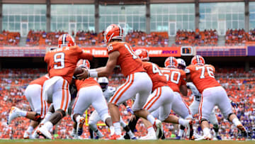 CLEMSON, SC - SEPTEMBER 01: Quarterback Trevor Lawrence #16 hands off to running back Travis Etienne #9 of the Clemson Tigers during the Tigers' football game against the Furman Paladins at Clemson Memorial Stadium on September 1, 2018 in Clemson, South Carolina. (Photo by Mike Comer/Getty Images)