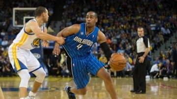 Mar 18, 2014; Oakland, CA, USA; q guard Stephen Curry (30) pulls on the jersey of Orlando Magic guard Arron Afflalo (4) during the second quarter at Oracle Arena. Mandatory Credit: Kelley L Cox-USA TODAY Sports