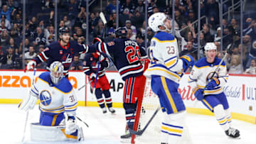 Nov 17, 2023; Winnipeg, Manitoba, CAN; Winnipeg Jets center Mason Appleton (22) celebrates his second period goal on Buffalo Sabres goaltender Eric Comrie (31) with Winnipeg Jets center Adam Lowry (17) at Canada Life Centre. Mandatory Credit: James Carey Lauder-USA TODAY Sports