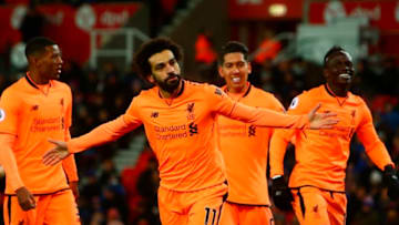 Liverpool's Egyptian midfielder Mohamed Salah (C) celebrates scoring their second goal during the English Premier League football match between Stoke City and Liverpool at the Bet365 Stadium in Stoke-on-Trent, central England on November 29, 2017. / AFP PHOTO / Geoff CADDICK / RESTRICTED TO EDITORIAL USE. No use with unauthorized audio, video, data, fixture lists, club/league logos or 'live' services. Online in-match use limited to 75 images, no video emulation. No use in betting, games or single club/league/player publications. / (Photo credit should read GEOFF CADDICK/AFP/Getty Images)