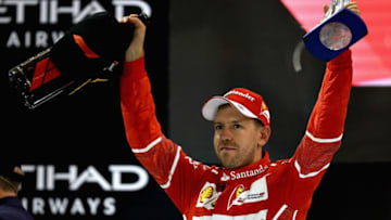 ABU DHABI, UNITED ARAB EMIRATES - NOVEMBER 26: Third place finisher Sebastian Vettel of Germany and Ferrari celebrates on the podium during the Abu Dhabi Formula One Grand Prix at Yas Marina Circuit on November 26, 2017 in Abu Dhabi, United Arab Emirates. (Photo by Mark Thompson/Getty Images)