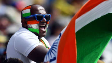 TOPSHOT - An Indian fan waves national flag on the third day of the second cricket Test match between Australia and India at the MCG in Melbourne on December 28, 2020. (Photo by WILLIAM WEST / AFP) / --IMAGE RESTRICTED TO EDITORIAL USE - STRICTLY NO COMMERCIAL USE-- (Photo by WILLIAM WEST/AFP via Getty Images)