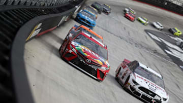 BRISTOL, TN - APRIL 07: Kyle Busch, driver of the #18 Skittles Toyota, and Brad Keselowski, driver of the #2 Discount Tire Ford, races during the Monster Energy NASCAR Cup Series Food City 500 at Bristol Motor Speedway on April 7, 2019 in Bristol, Tennessee. (Photo by Chris Graythen/Getty Images)