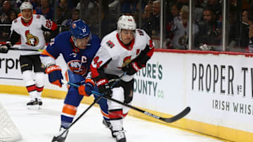 NEW YORK, NEW YORK - NOVEMBER 05: Anders Lee #27 of the New York Islanders and Jean-Gabriel Pageau #44 of the Ottawa Senators battle for the puck at Barclays Center on November 05, 2019 in New York City. (Photo by Mike Stobe/NHLI via Getty Images)