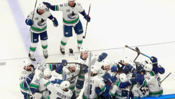EDMONTON, ALBERTA - AUGUST 14: The Vancouver Canucks celebrate their overtime victory over the St. Louis Blues in Game Two of the Western Conference First Round during the 2020 NHL Stanley Cup Playoffs at Rogers Place on August 14, 2020 in Edmonton, Alberta, Canada. The Canucks defeated the Blues 4-3 in overtime. (Photo by Jeff Vinnick/Getty Images)
