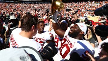 Oct 12, 2019; Dallas, TX, USA; Oklahoma Sooners nose guard Neville Gallimore (90) celebrates with the Golden Hat trophy after a victory against the Texas Longhorns at Cotton Bowl. Mandatory Credit: Matthew Emmons-USA TODAY Sports