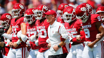 NORMAN, OK - SEPTEMBER 3: Head coach Brent Venables leads the Oklahoma Sooners arm in arm to the end zone before a game against the UTEP Miners at Gaylord Family Oklahoma Memorial Stadium on September 3, 2022 in Norman, Oklahoma. Oklahoma won 45-13. (Photo by Brian Bahr/Getty Images)