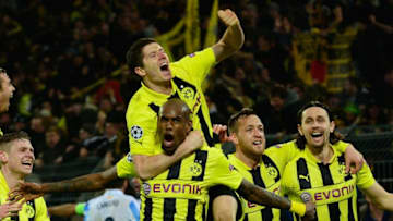 Dortmund's Brazilian defender Felipe Santana (C) celebrates with his teamates after the UEFA Champions League quarter-final second-leg football match Borussia Dortmund vs Malaga CF in Dortmund, western Germany on April 9, 2013. Dortmund won the match 3-2 to qualify for the semi-finals. AFP PHOTO / JOHN MACDOUGALL (Photo credit should read JOHN MACDOUGALL/AFP/Getty Images)
