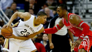 Jan 15, 2014; New Orleans, LA, USA; New Orleans Pelicans power forward Anthony Davis (23) is defended by Houston Rockets power forward Dwight Howard (12) during the second half of a game at the New Orleans Arena. The Rockets defeated the Pelicans 103-100. Mandatory Credit: Derick E. Hingle-USA TODAY Sports