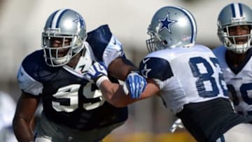 Jul 31, 2014; Oxnard, CA, USA; Dallas Cowboys defensive end George Selvie (99) is defended by tight end Jason Witten (82) at training camp at the River Ridge Fields. Mandatory Credit: Kirby Lee-USA TODAY Sports