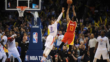 Apr 5, 2015; Oklahoma City, OK, USA; Houston Rockets guard James Harden (13) shoots the ball as Oklahoma City Thunder guard Russell Westbrook (0) defends during the fourth quarter at Chesapeake Energy Arena. Mandatory Credit: Mark D. Smith-USA TODAY Sports