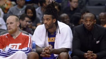 Jan 10, 2014; Los Angeles, CA, USA; Los Angeles Lakers players Chris Kaman (left), Jordan Hill (center) and Kobe Bryant react during the game against the Los Angeles Clippers at Staples Center. Mandatory Credit: Kirby Lee-USA TODAY Sports